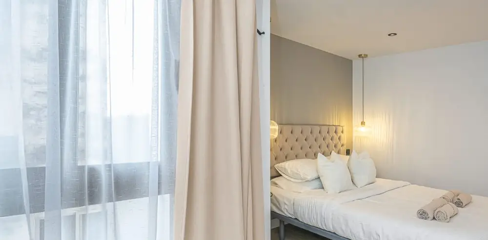 Early light across a linen-dressed bed