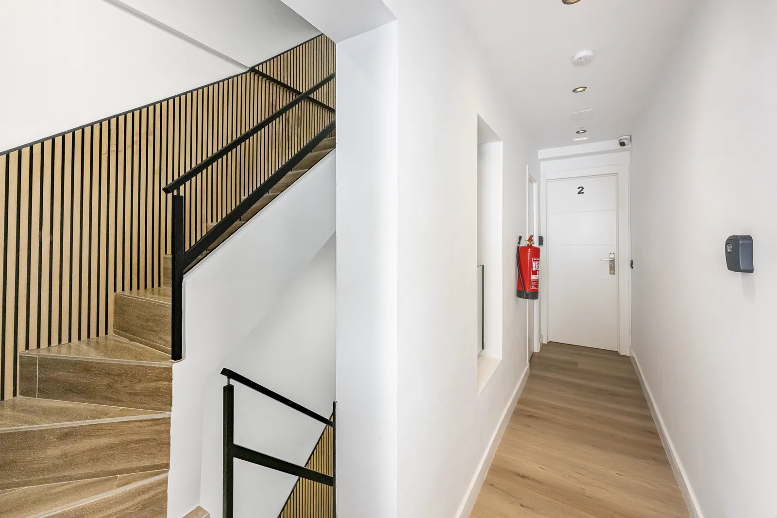 The corridor to Room 2: the oak stair, and the door marked 2 at the end