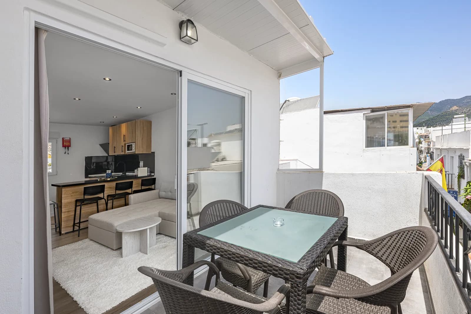 Room 5: the terrace table and four chairs, the sliding doors open onto the sitting room